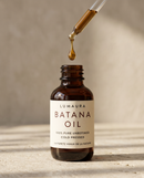Raw batana oil bottle for hair growth on a neutral backdrop