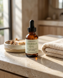 Cold-pressed soursop graviola oil bottle on a neutral backdrop
